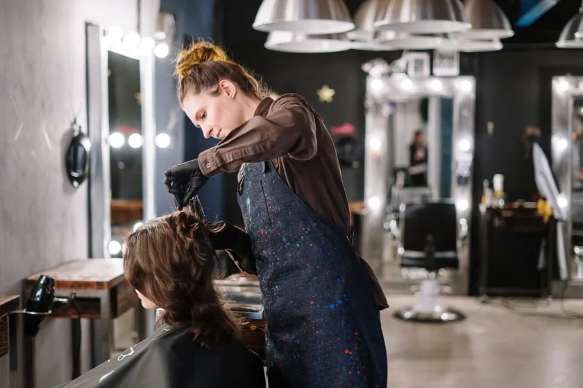 Estilista trabajando el cabello de una clienta en un salón de belleza